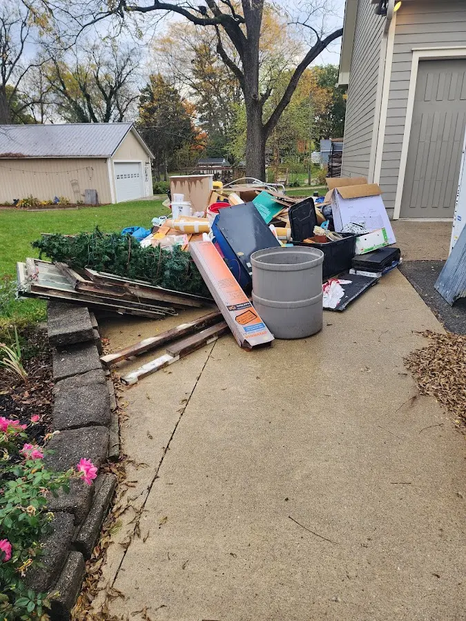 Dumpster being loaded with debris for Estate Cleanout Dumpster Rental in Peshtigo